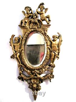 1a2- Miroir ovale biseauté Napoléon III, armature en bronze doré avec 4 angelots