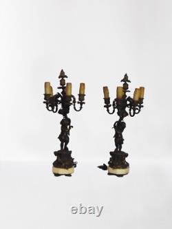 Paire de candelabres Napoleon III aux amours en Bronze doré/bronze patiné