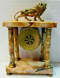 Pendule marbre style Empire à colonnes et lion en bronze