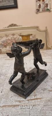 Unique French dark bronze Candle holder With Two cherub puttos holding it