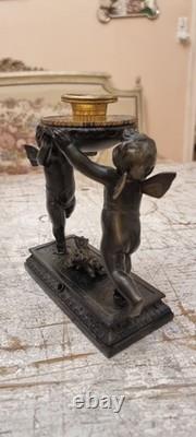 Unique French dark bronze Candle holder With Two cherub puttos holding it
