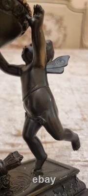 Unique French dark bronze Candle holder With Two cherub puttos holding it