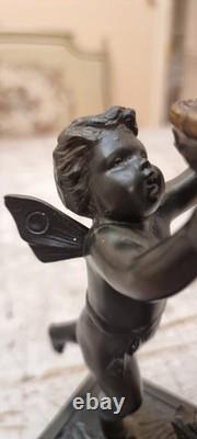 Unique French dark bronze Candle holder With Two cherub puttos holding it