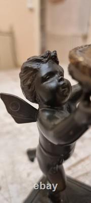 Unique French dark bronze Candle holder With Two cherub puttos holding it